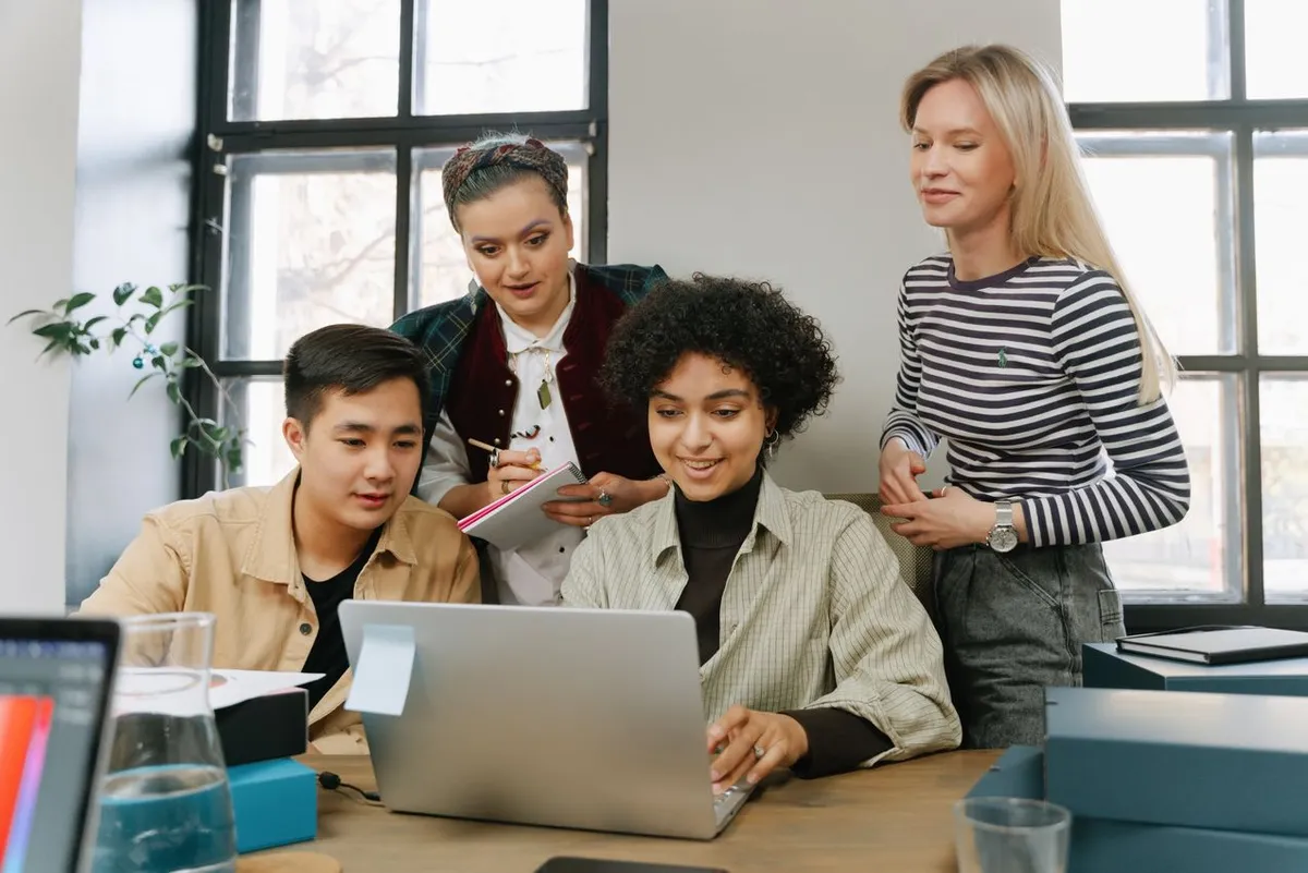 Team reviewing a plan on a laptop